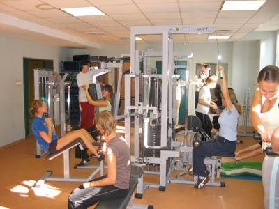 Female students exercising on an atlas for women