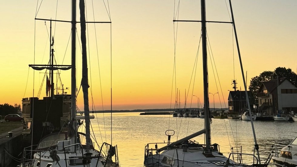 a photo - yachts in the harbour at sunset