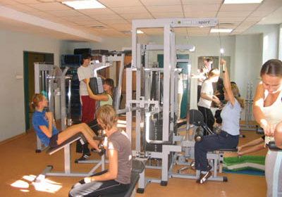 Female students exercising on an atlas for women