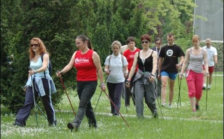 A group of students practicing Nordic walking in front of the the University of Lodz Sports Facility building